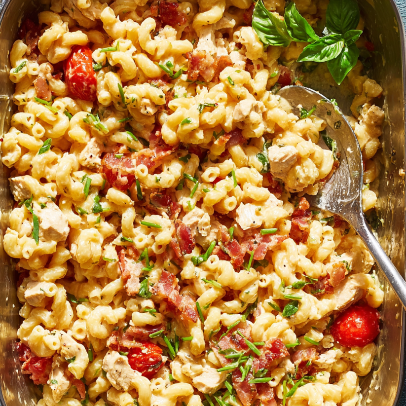 A dish of pasta with tomatoes and bacon.