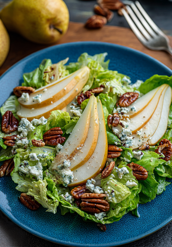 A salad with pear, blue cheese, and walnuts.