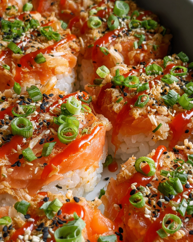 A plate of salmon sushi bake with sauce.