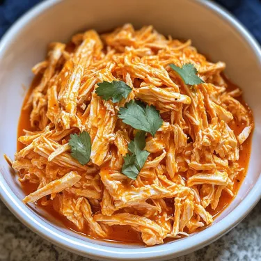 A bowl of shredded buffalo chicken.
