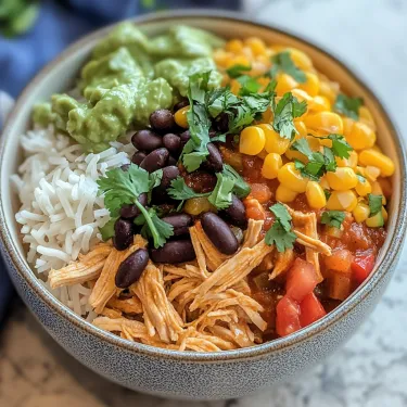 A bowl of food with rice, beans, corn, and avocado.