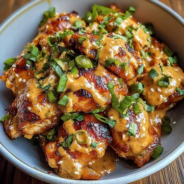 A bowl of chicken with a sauce.