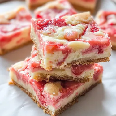 A stack of dessert squares with a white plate.