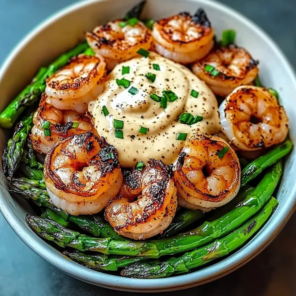 A bowl of shrimp and asparagus.