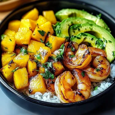 A bowl of food with shrimp, avocado, and pineapple.
