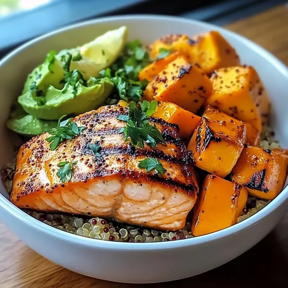 A bowl of food with fish and vegetables.
