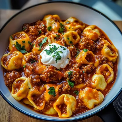 A bowl of pasta with meat sauce.