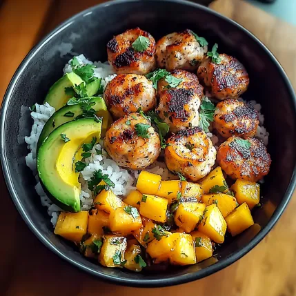 A bowl of food with rice, meat, and vegetables.