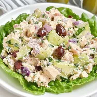 A white plate with a salad on it.