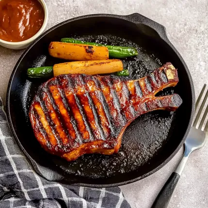 A plate of meat with a fork next to it.
