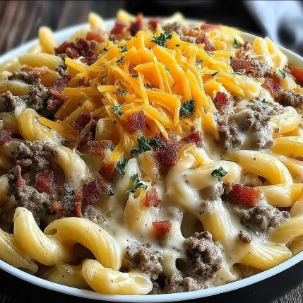 A plate of pasta with cheese and bacon.