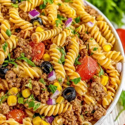 A bowl of pasta with meat and vegetables.