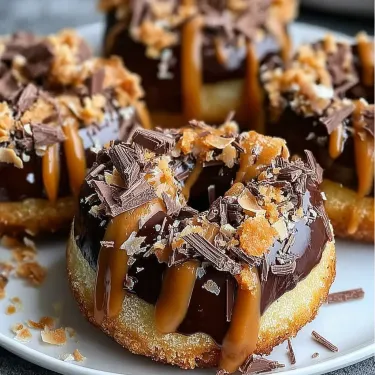 A plate of chocolate donuts with caramel topping.