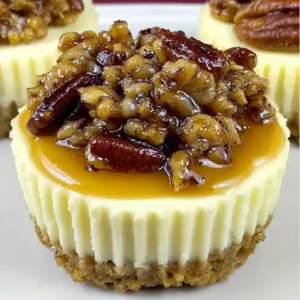 A slice of cheesecake with pecans on top.
