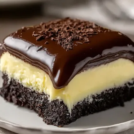 A chocolate dessert with chocolate chips on top.