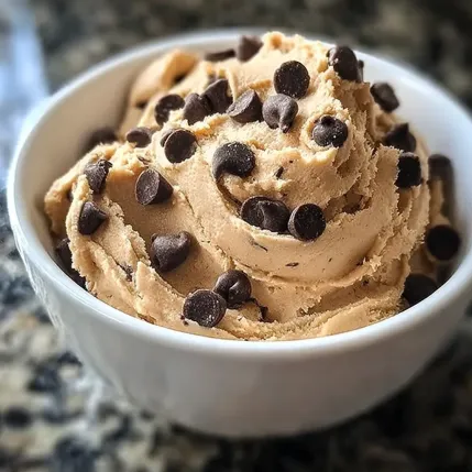 A bowl of chocolate ice cream with chocolate chips.