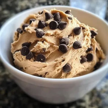 A bowl of chocolate ice cream with chocolate chips.