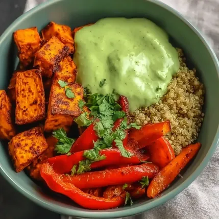 A bowl of food with carrots, peppers, and rice.