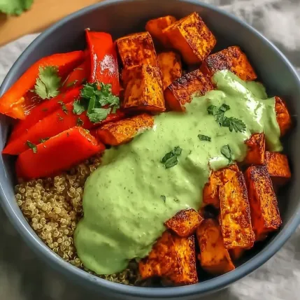 A bowl of food with a green sauce.