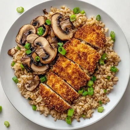 A plate of rice with mushrooms and chicken.