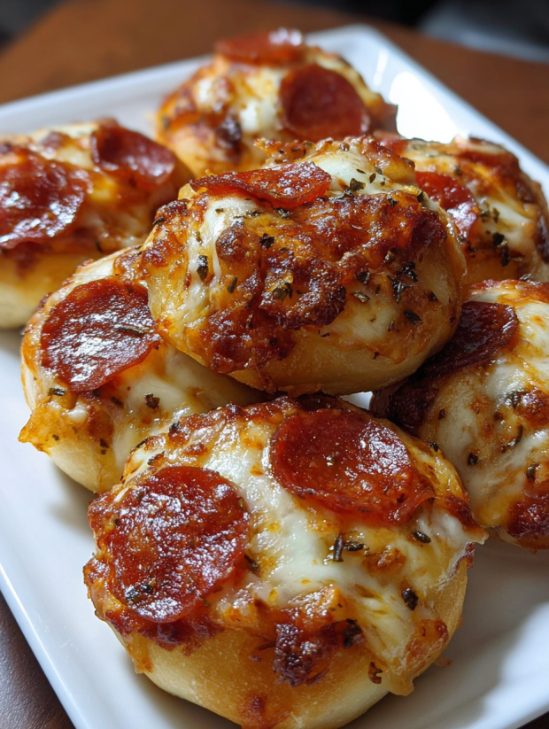 A plate of cheesy pizza roll-ups snack.