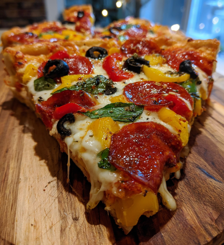 A pizza with a Christmas tree on top.