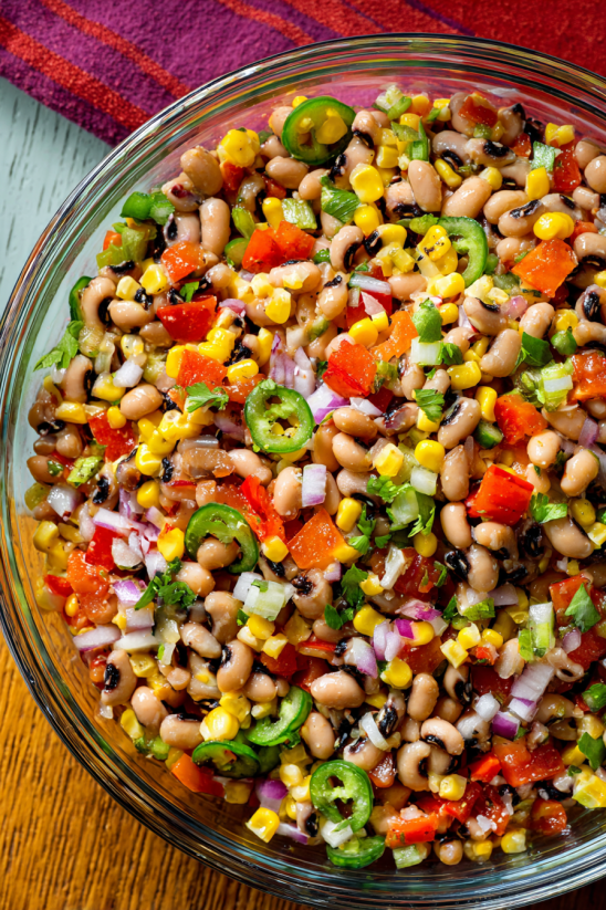 A bowl of cowboy caviar with various vegetables.