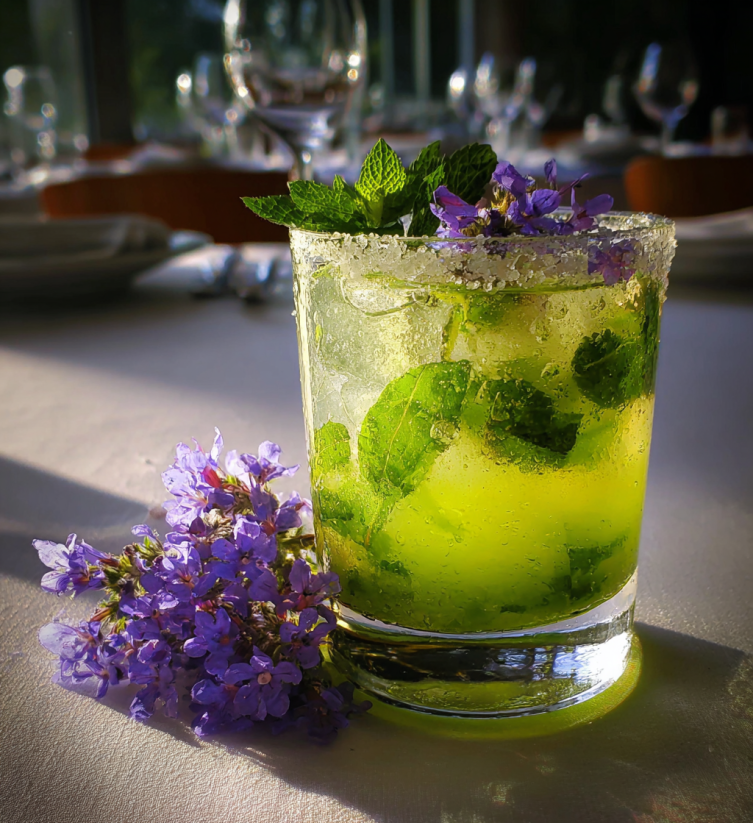 A glass of a virgin lavender mojito with mint leaves.