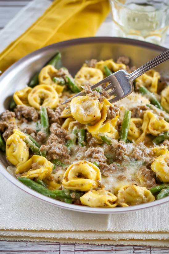 A plate of food with a fork in it.