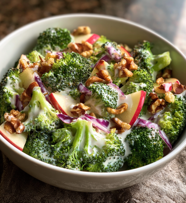 A bowl of broccoli salad with nuts.