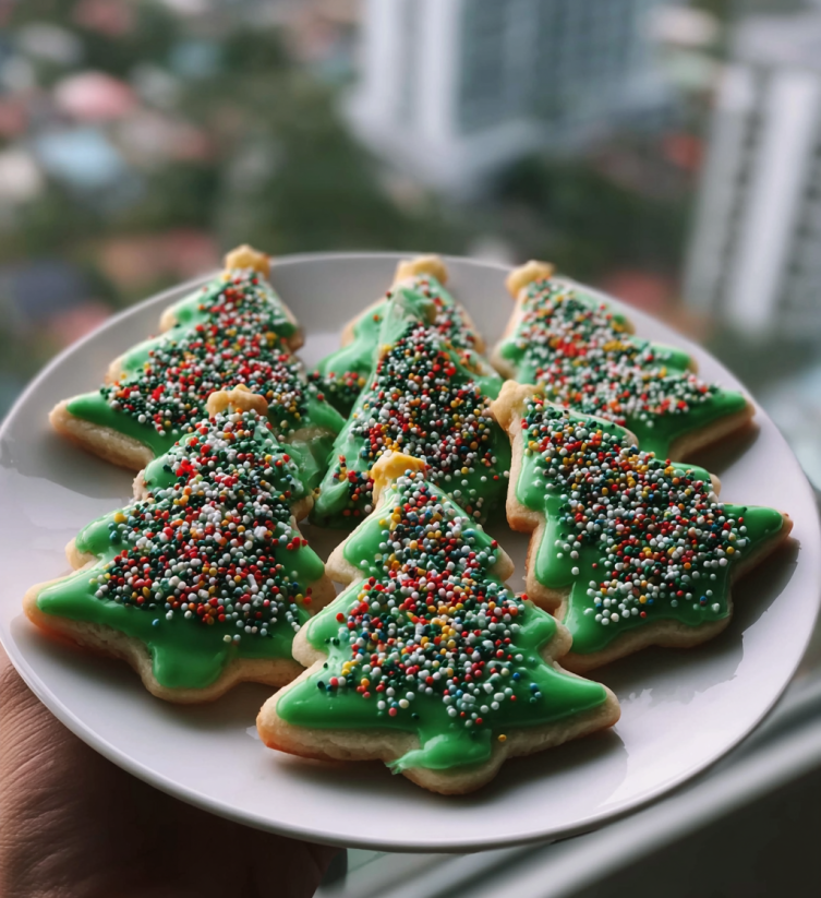 A plate of green and white cookies decorated like Christmas trees.