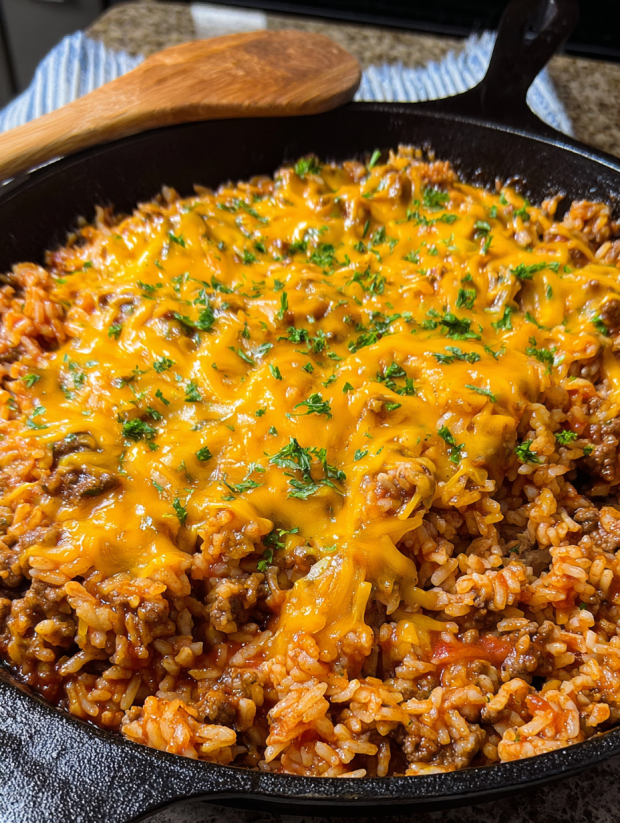 A skillet filled with a cheesy sloppy joe rice dish.