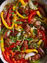 A dish of sausage and peppers.