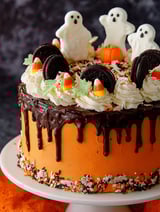 A Halloween themed layer cake with chocolate icing and white frosting.