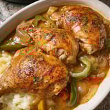 A plate of smothered chicken legs.