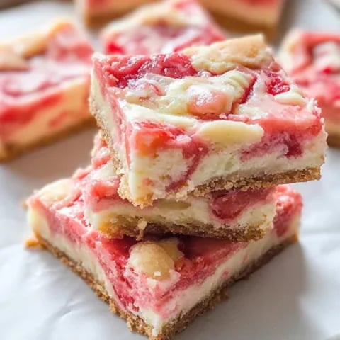 A stack of dessert squares with a white plate.